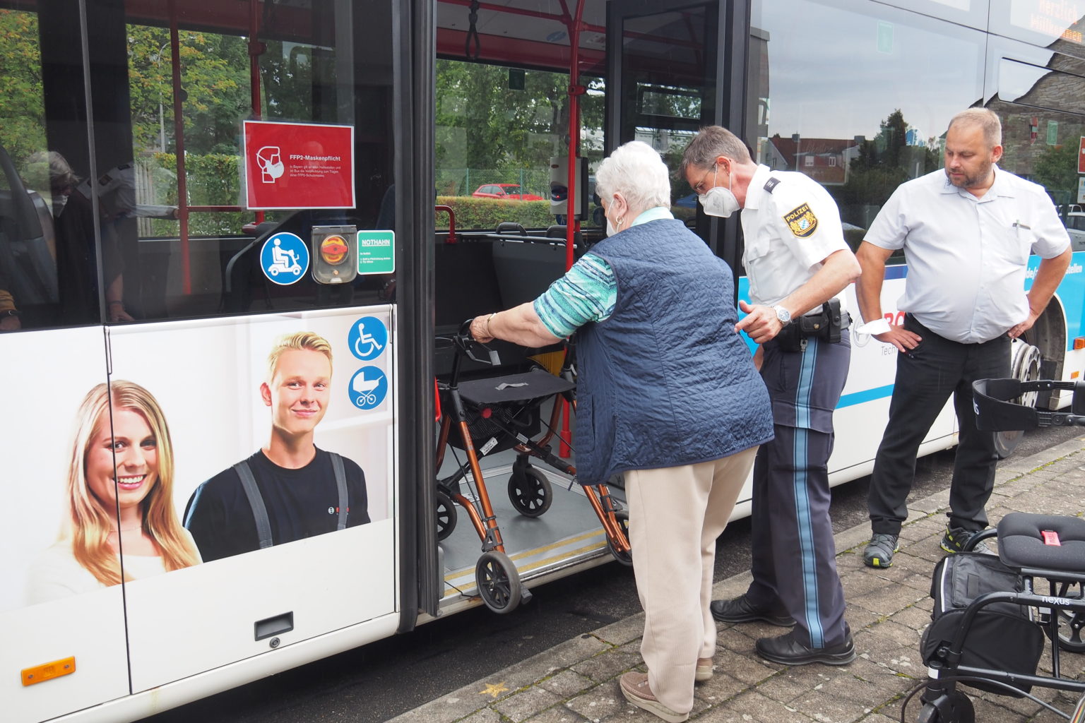 An der Bus-Station übt eine Kursteilnehmerin mit Verkehrserzieher Franz Werner (Mitte) und Busfahrer Harald Wessely das Einsteigen.
